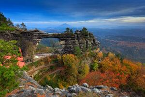 pravcicka brana, rock monument, sandstone gate. biggest natural bridge in europe. bohemian switzerland, hrensko, czech republic. rocky landscape, autumn. beautiful nature with stone, forest and fog.